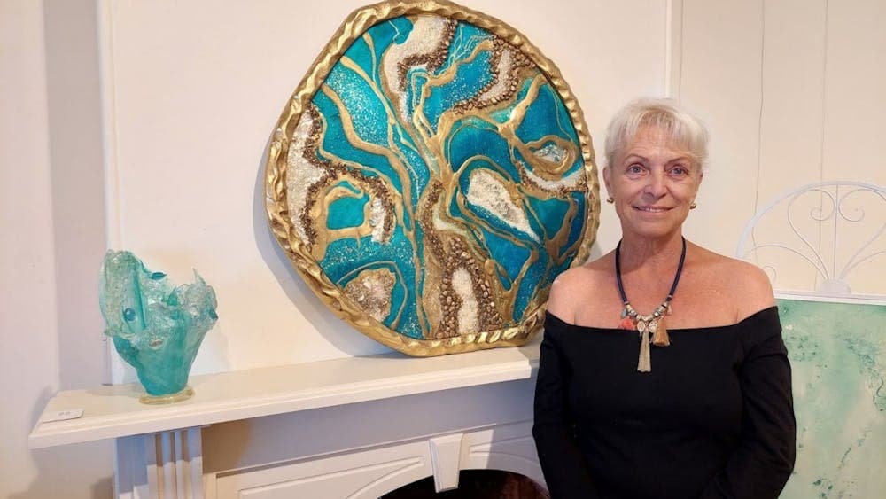 Beatrice with her resin circular Egyptian Geode, using her favorite color turquoise.