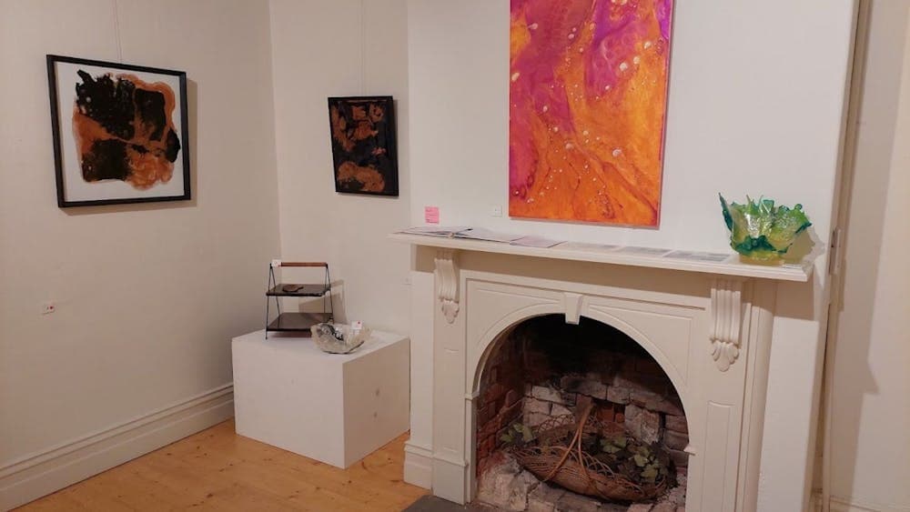 Display of Beatrice's resin artwork featuring the hot colors of pink and orange in 'Hell Fire'