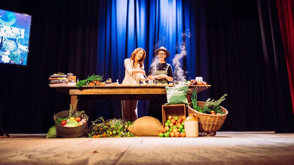 Chef Cat Clarke cooking on stage with Kara Monssen