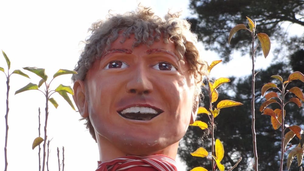 Sculpture of a smiling head on a pole