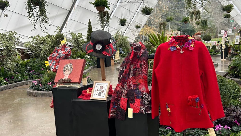 red coloured artwork and clothing on display