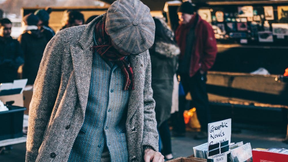person dressed in winter clothes looking for books