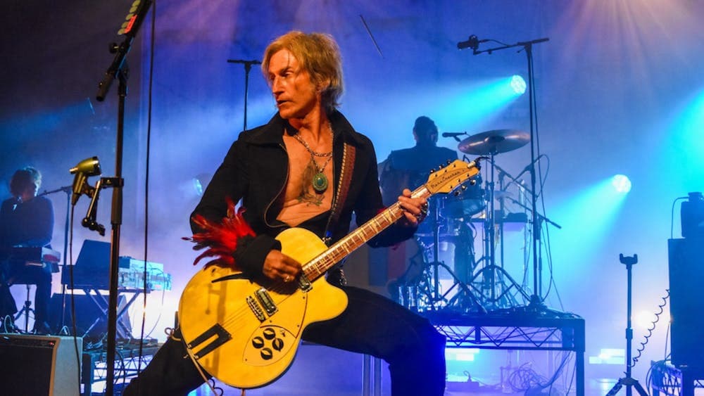 Tim Rogers from You Am I rocking out on stage in a low pose