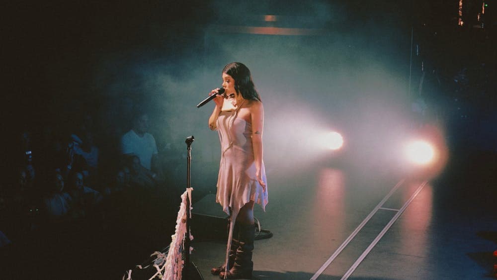 Thelma on stage holding her microphone