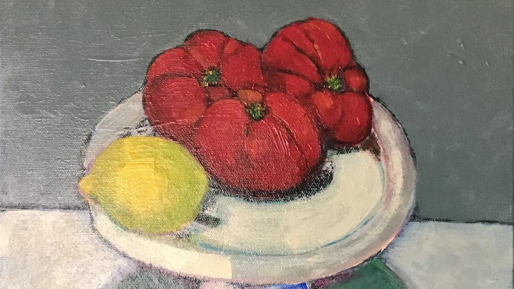 Still life painting of tomatoes and lemon on a tall platter in front of grey background.
