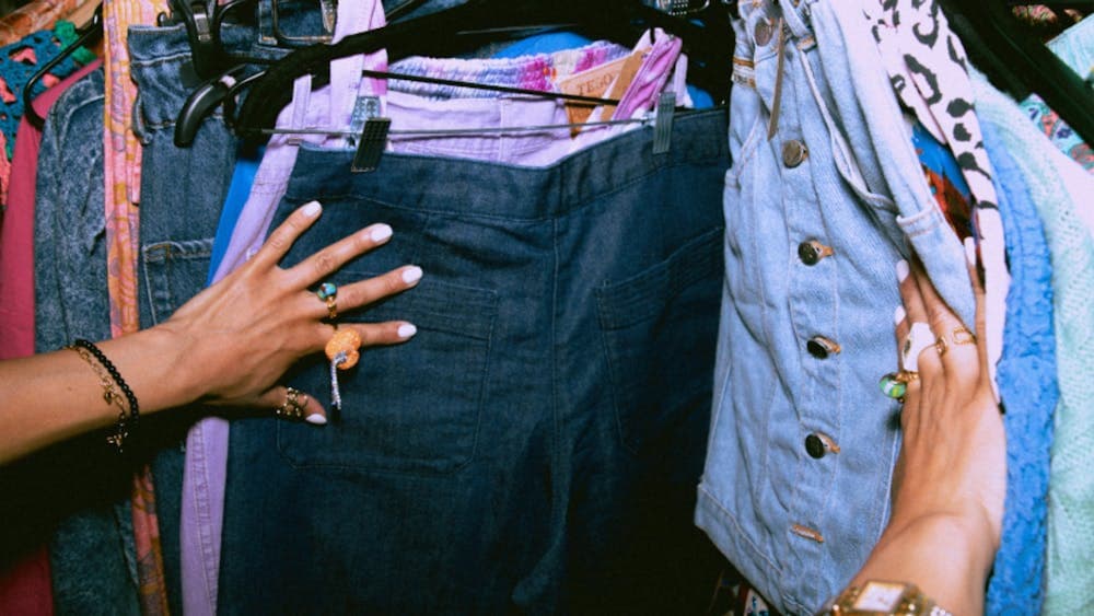 Looking through a clothing rack at The Big Thrift Market