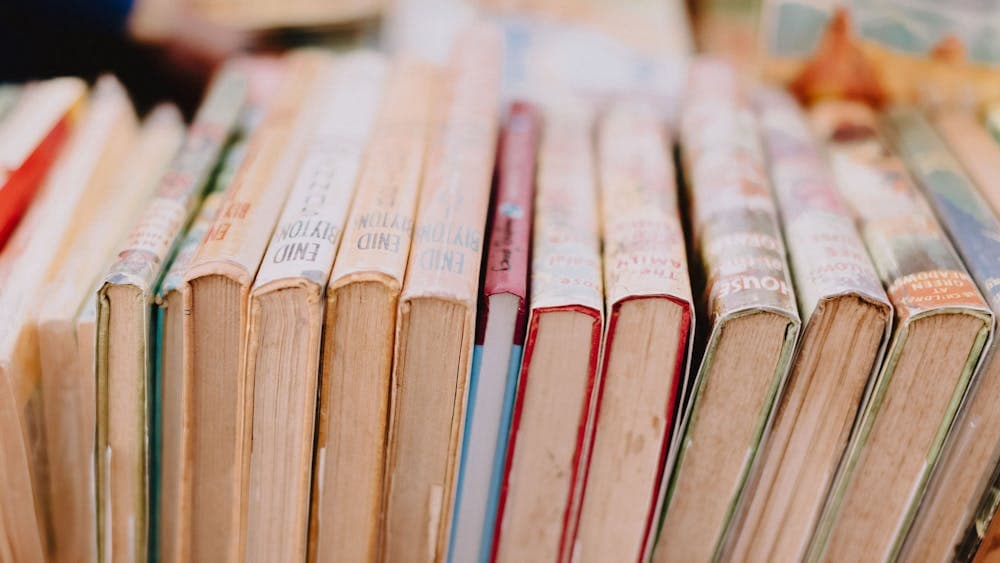 A stacks of books, lined up next to each other.