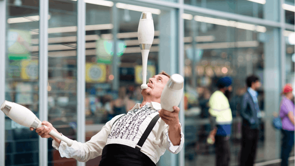 The Great Dave juggling three bowling pins
