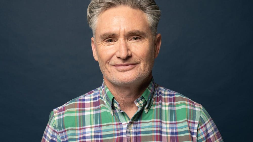 Man In green shirt looks at camera