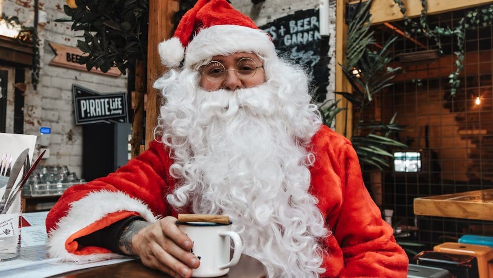 Santa holding a cup of hot drink at Hop Temple