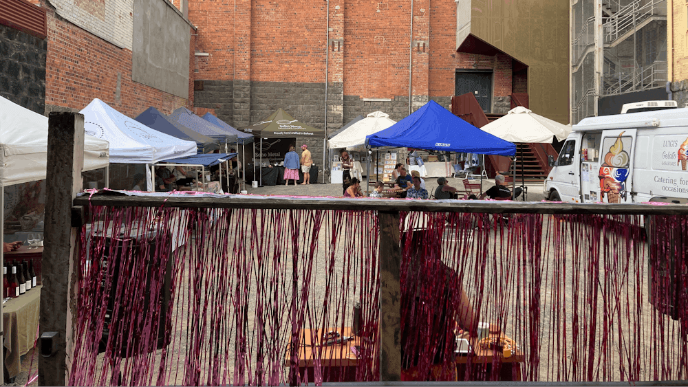 scene of a carpark filled with market stalls