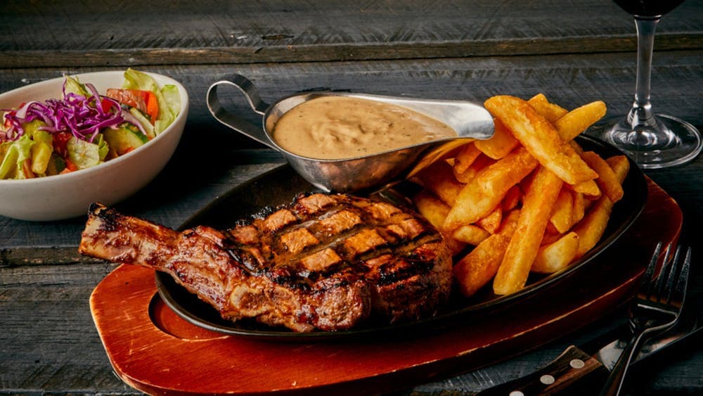 Ribeye steak with chips, sauce & salad