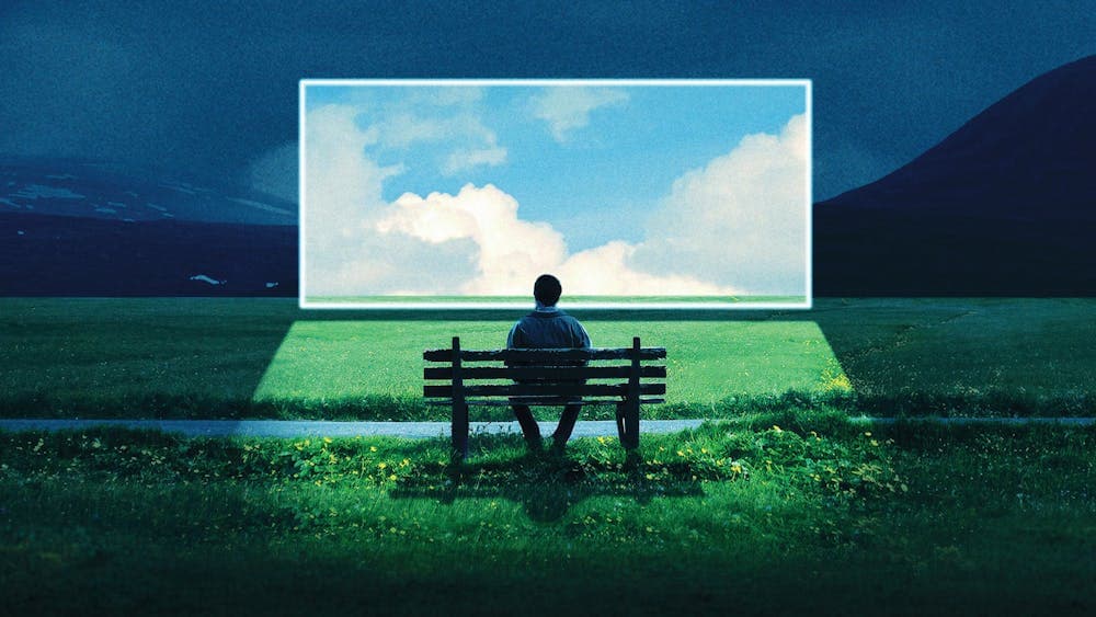 Person seated on bench looking out over landscape