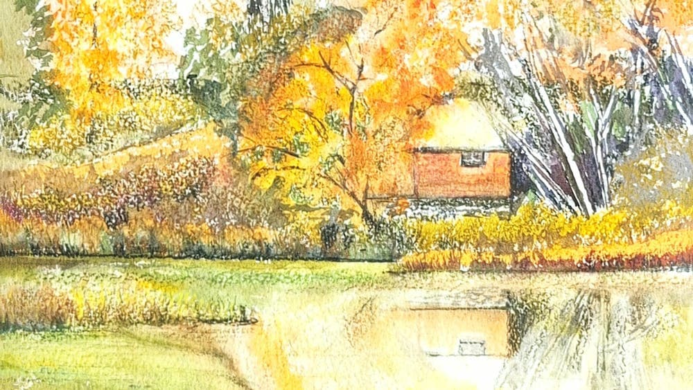 Autumnal colours  of orange and yellow surround a red building