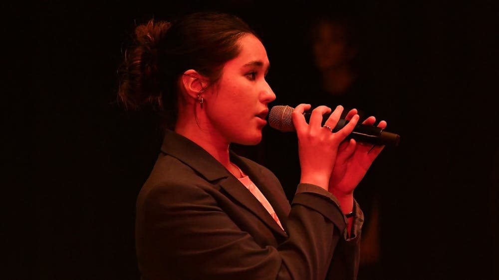Girl holding a micropgone and singing