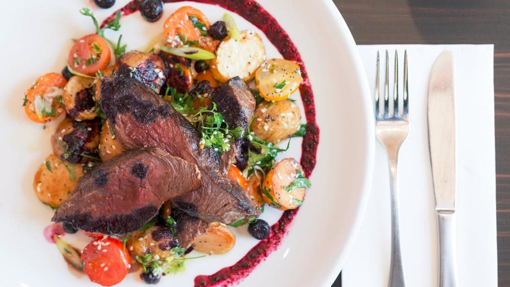 Seared Kangaroo with chat potatoes, cherry tomatoes, and blueberries
