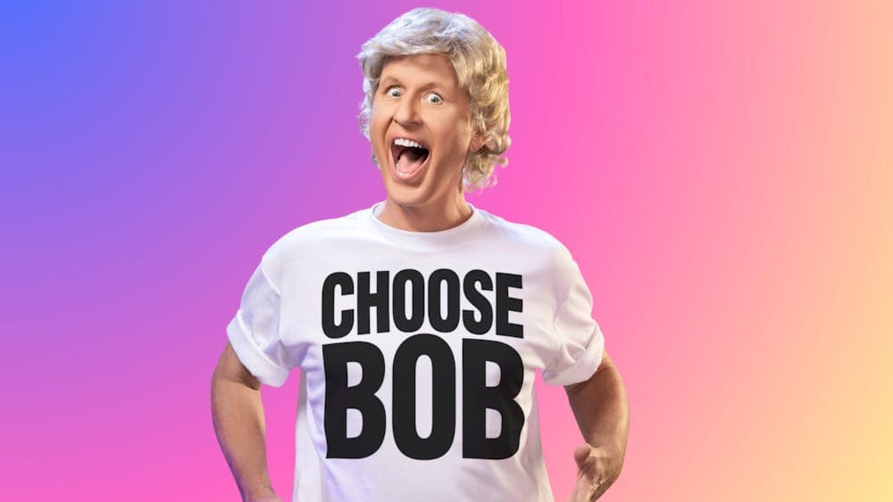 Bob Downe looking like George Michael from Wham! The iconic t-shirt reads 'Choose Bob'.