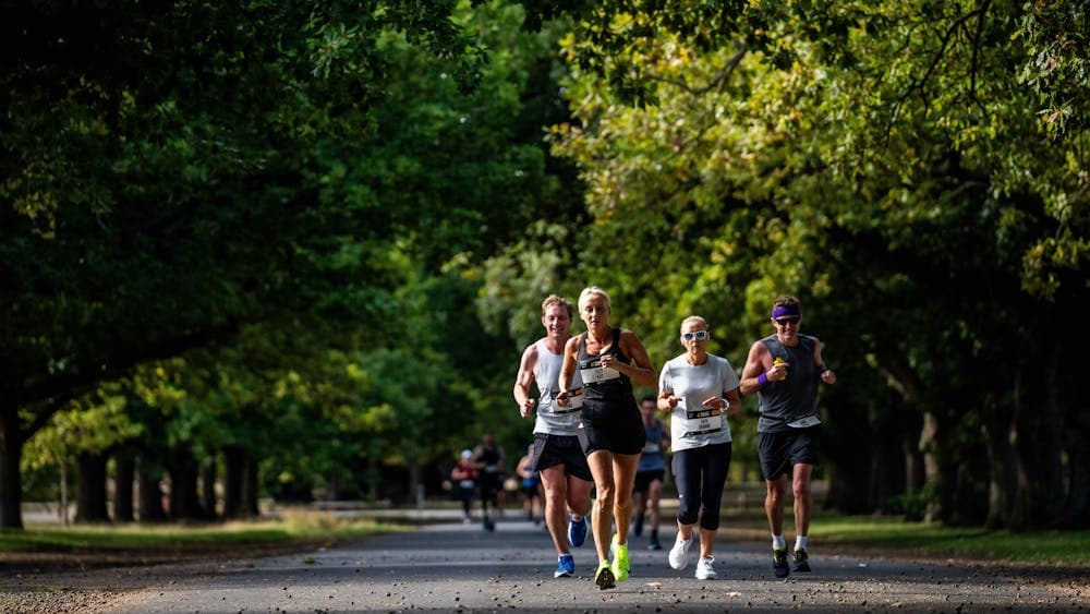A group of runners jogging through Victoria Park in Ballarat