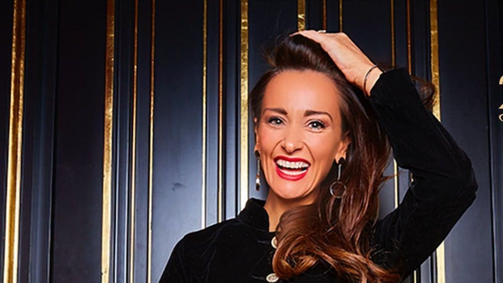 Kyla Kirkpatrick - The Champagne Dame holding a bottle of champagne