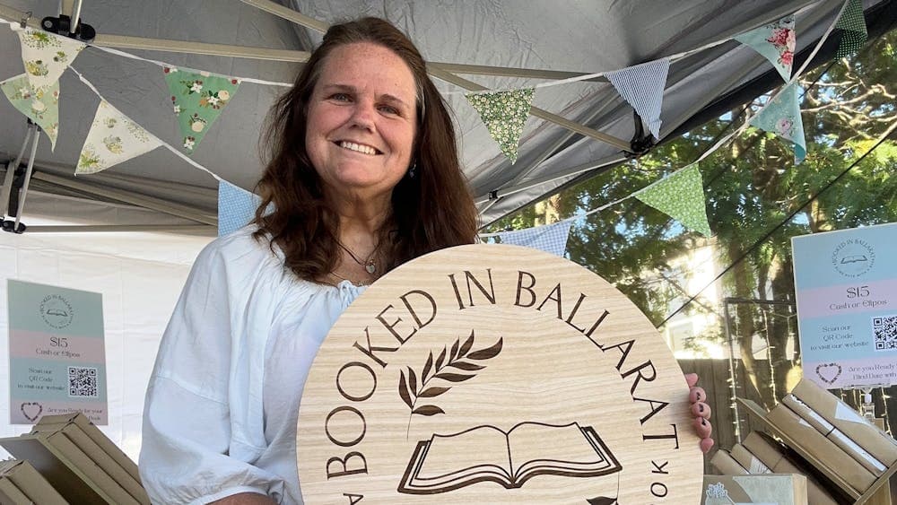 Amanda holding Booking in Ballarat sign