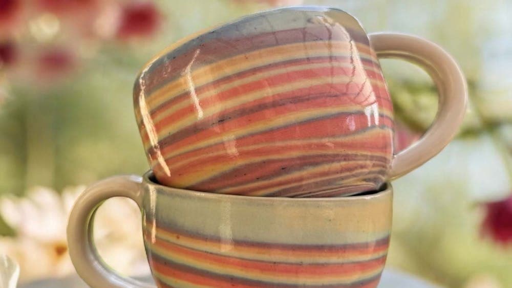 2 stacked rainbow coloured cups