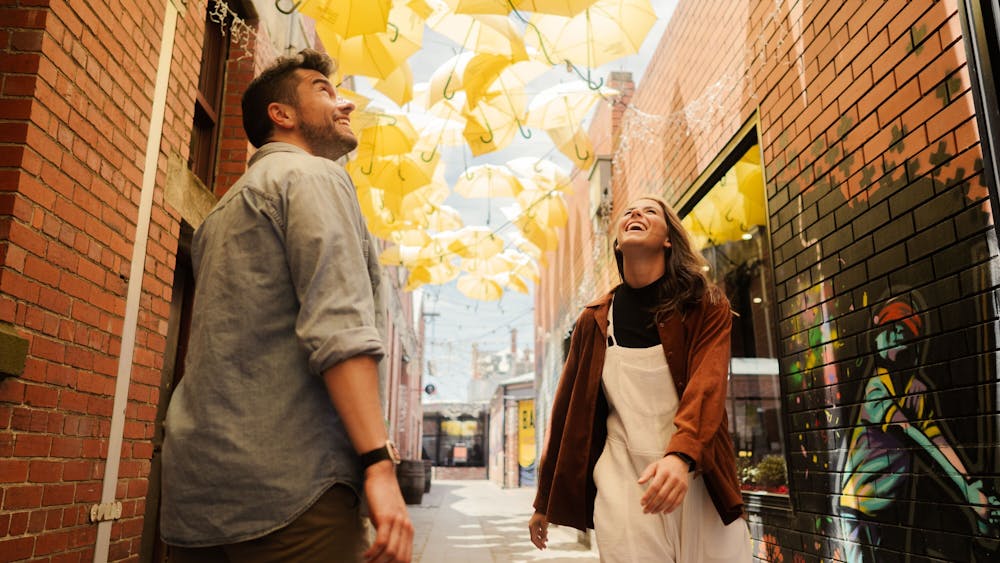 two people looking at yellow umbrellas