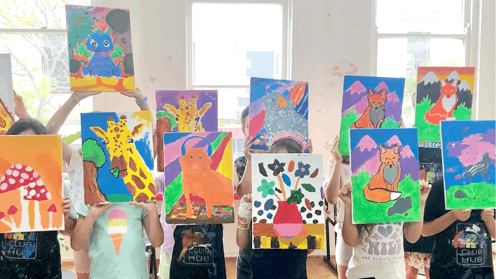 group of children showing their paintings after a Casual Canvas session at The Art Club Hub