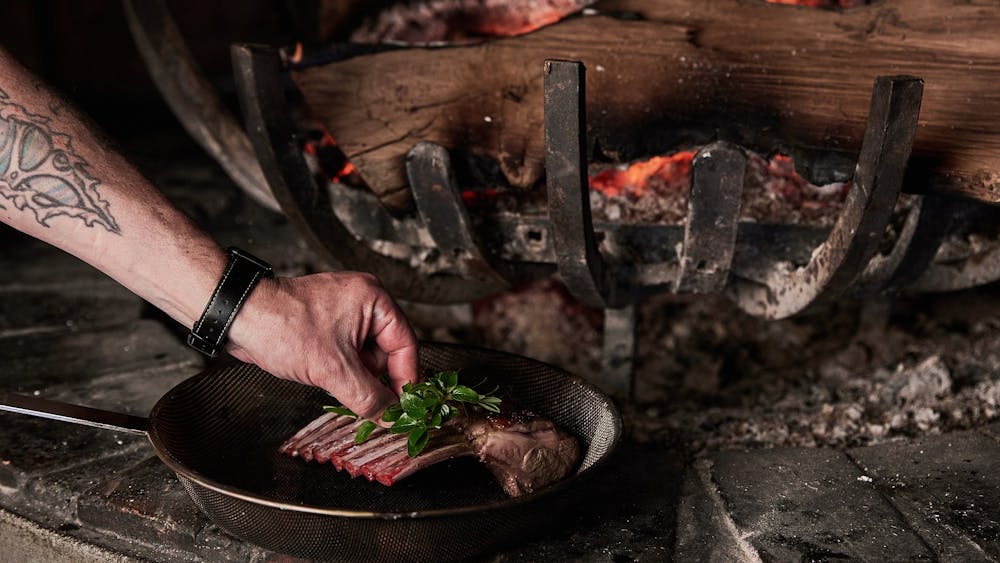 meat being cooked in a pan at Tuki restaurant