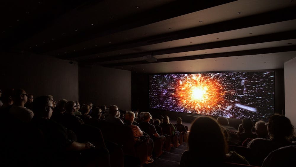 Audience watching 3D show inside theatre