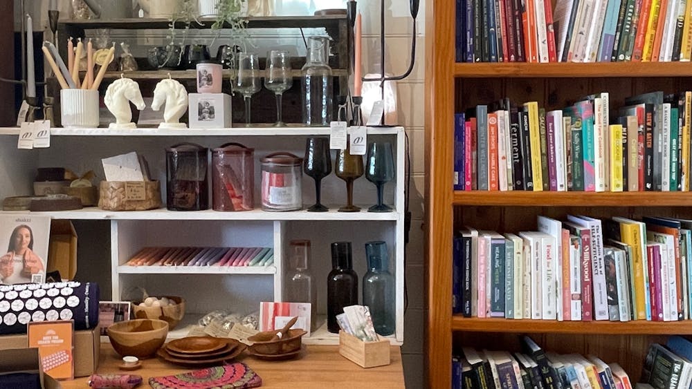 books on a shelf and other decorative items on a table