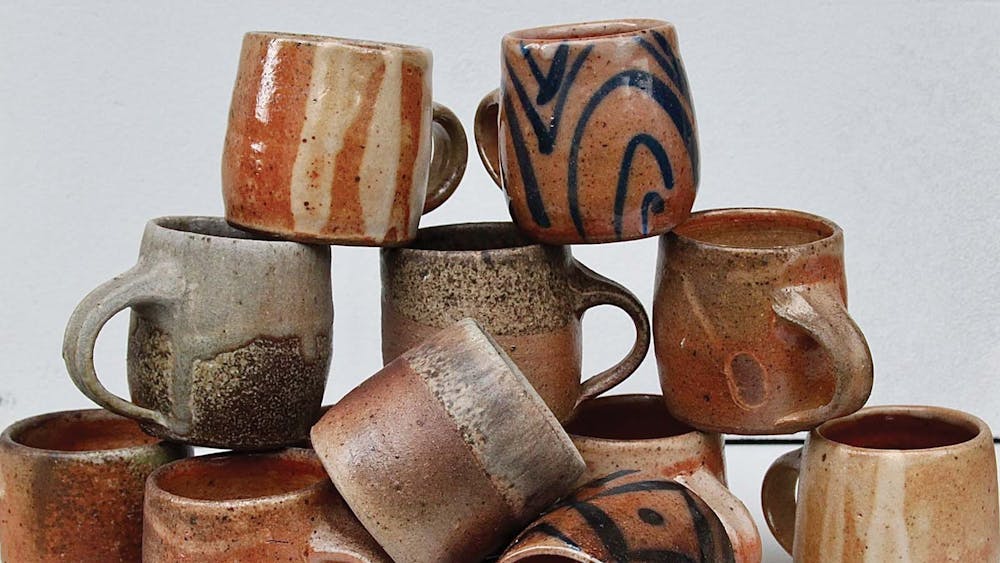 a stack of woodfired mugs