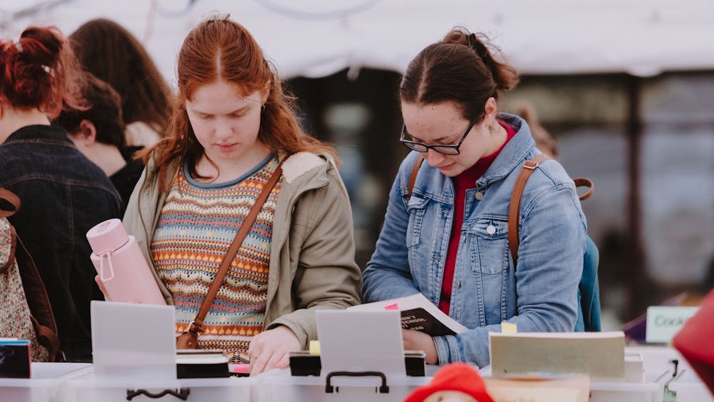Two young women look at books for sale at the Clunes Booktown Festival