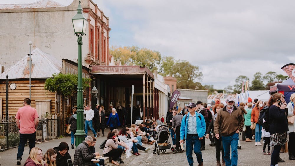 Main Street of Clunes filled with people and stalls for the Clunes Booktown Festival