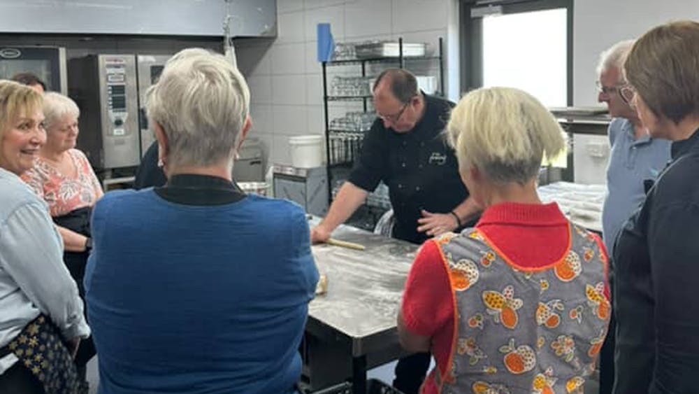 Chef Mark show how to knead gnocchi to the cooking class students