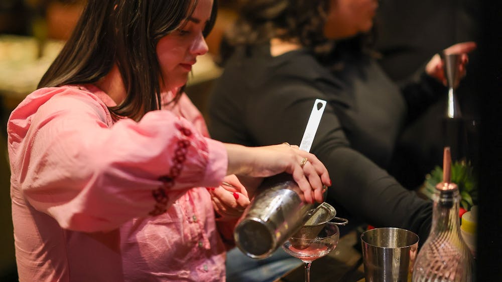 two women preparing a cocktail at Itinerant Spirits cocktail making class