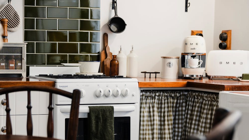 View of kitchen with green tiles