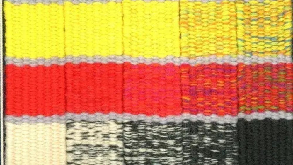 Blue, yellow, red and black diagonal stripped tapestry
