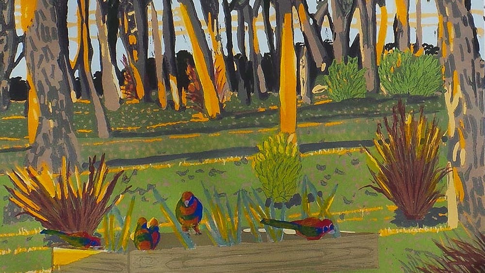 Sun beaming through bush and trees with red birds in the foreground