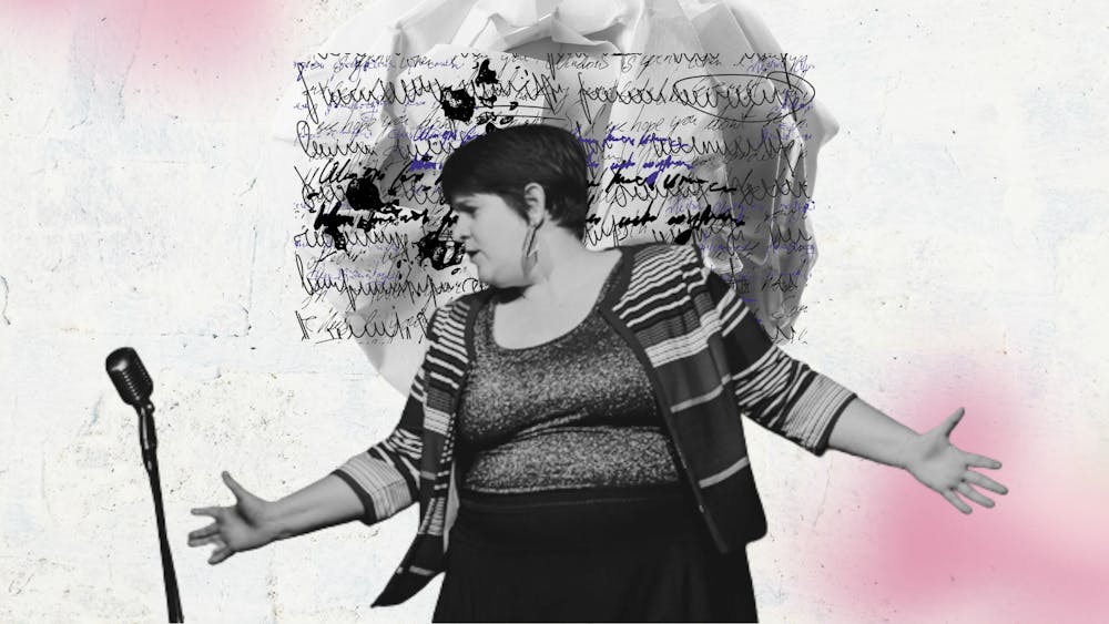 A poet performing actively with hands out in front of a mic. Background of scrunched paper & writing