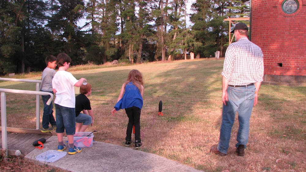 Children standing around a water rocket
