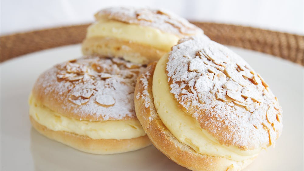 Beestings - melt-in-your-mouth buns filled with velvety custard and topped with toffeed almonds