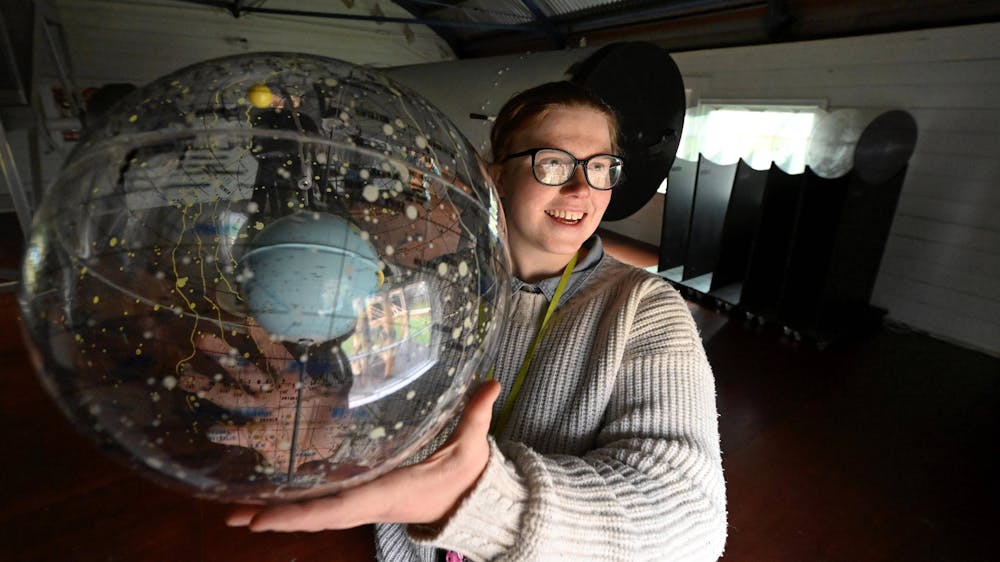 Person holding celestial sphere