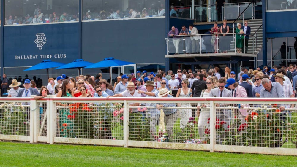 A crowd overseeing the racing action on the track