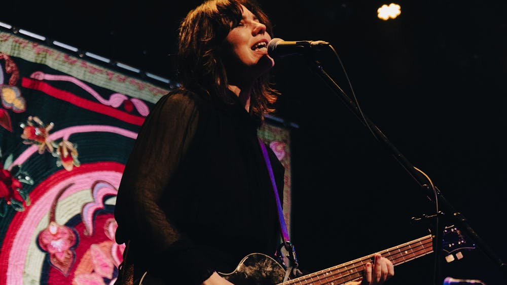 Kathleen Halloran playing guitar at Her Majesty's Theatre Ballarat
