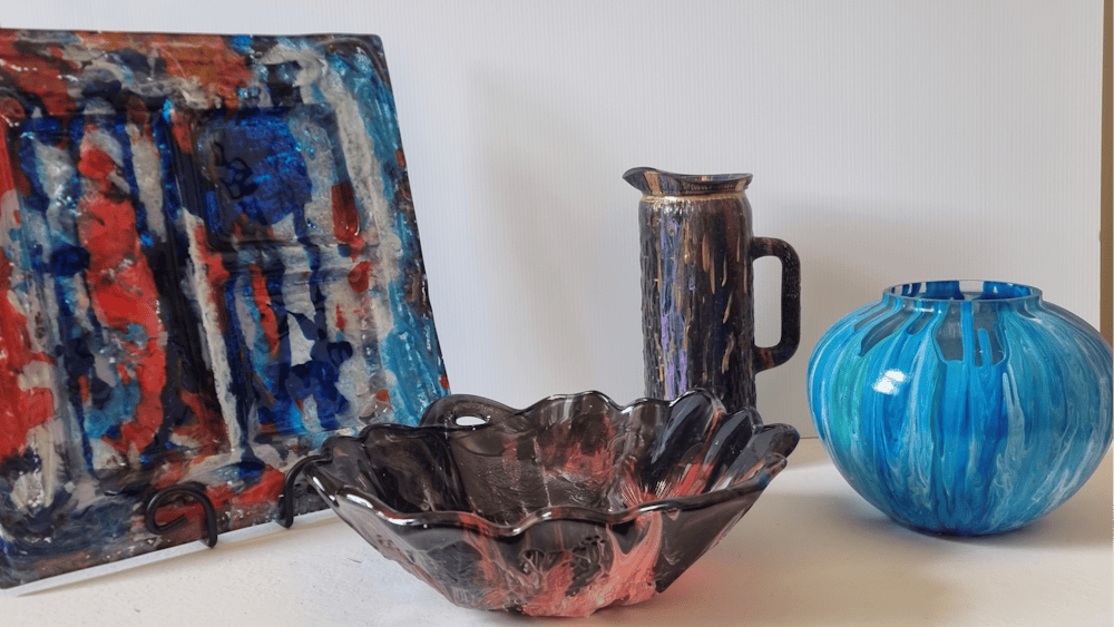 The image depicts four of  Bill's colorful acrylic Paint Pour Glassware