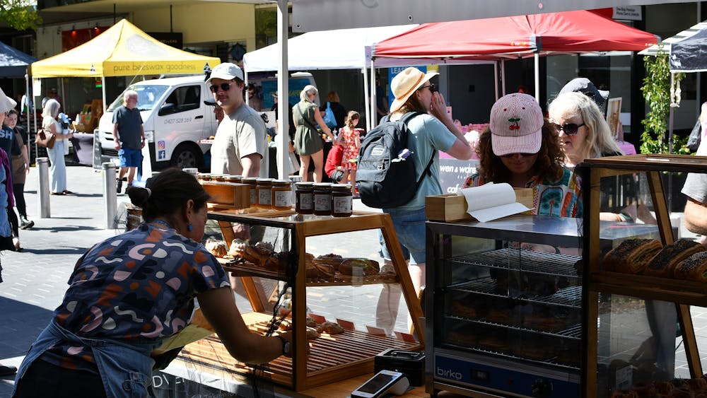 A stall holder arranging their goods