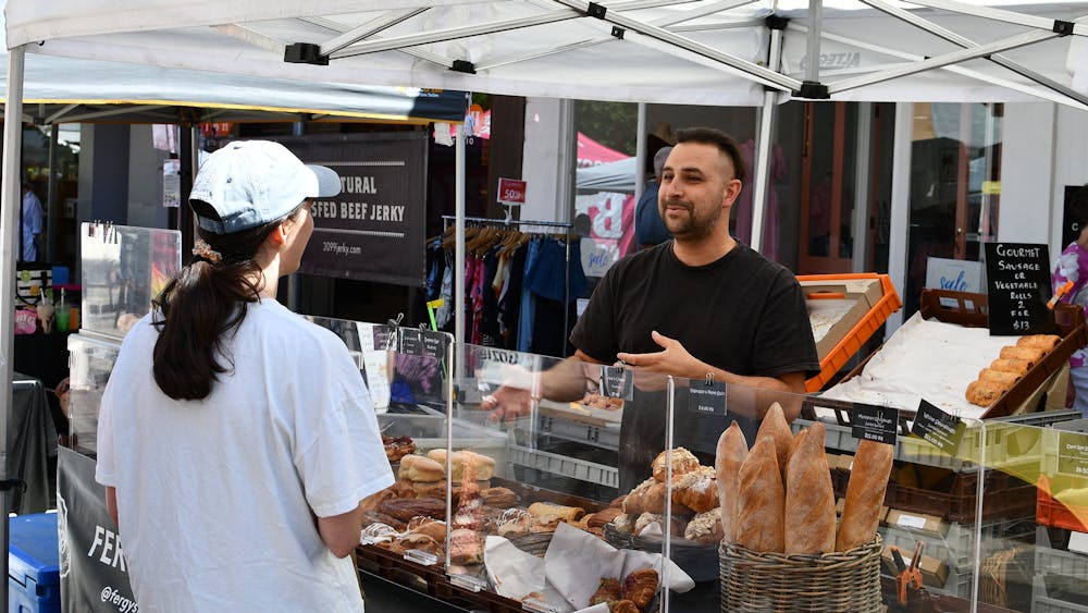 An enthusiatic stallholder talking to a customer