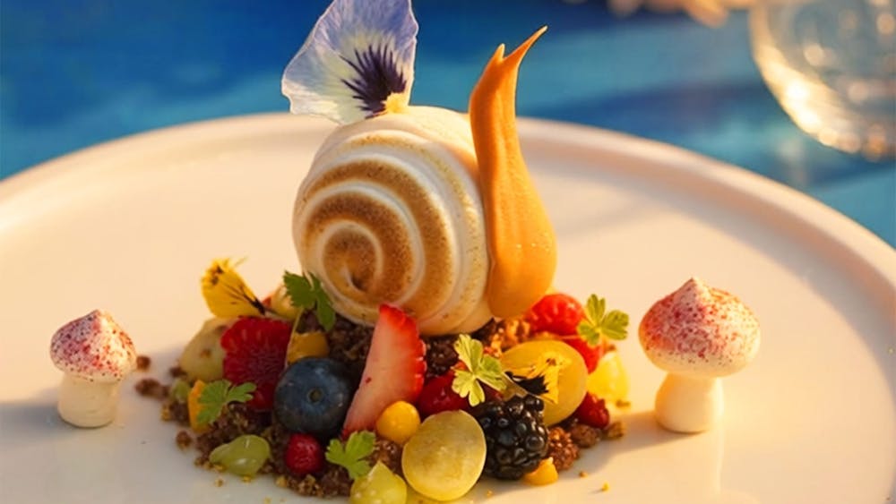 A gourmet dessert styled as a forest scene featuring a snail-shaped mousse, surrounded by berries