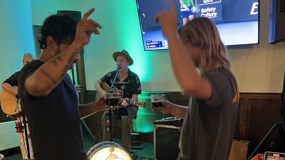 People dancing and enjoying live music inside the Courthouse Hotel during a lively event.