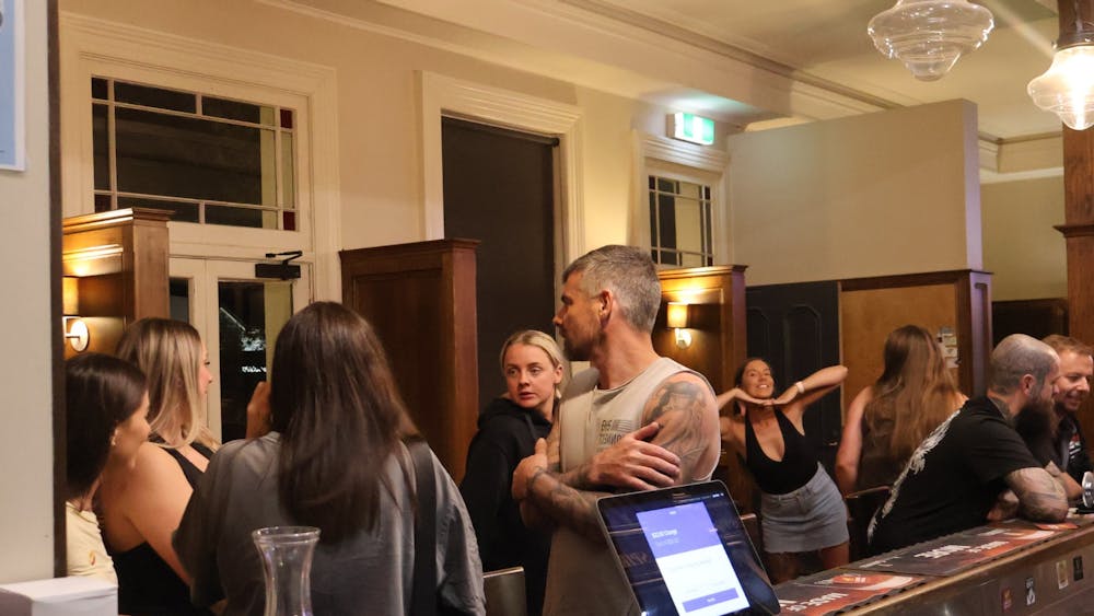 Guests gathered inside the Courthouse Hotel bar during a lively birthday celebration.